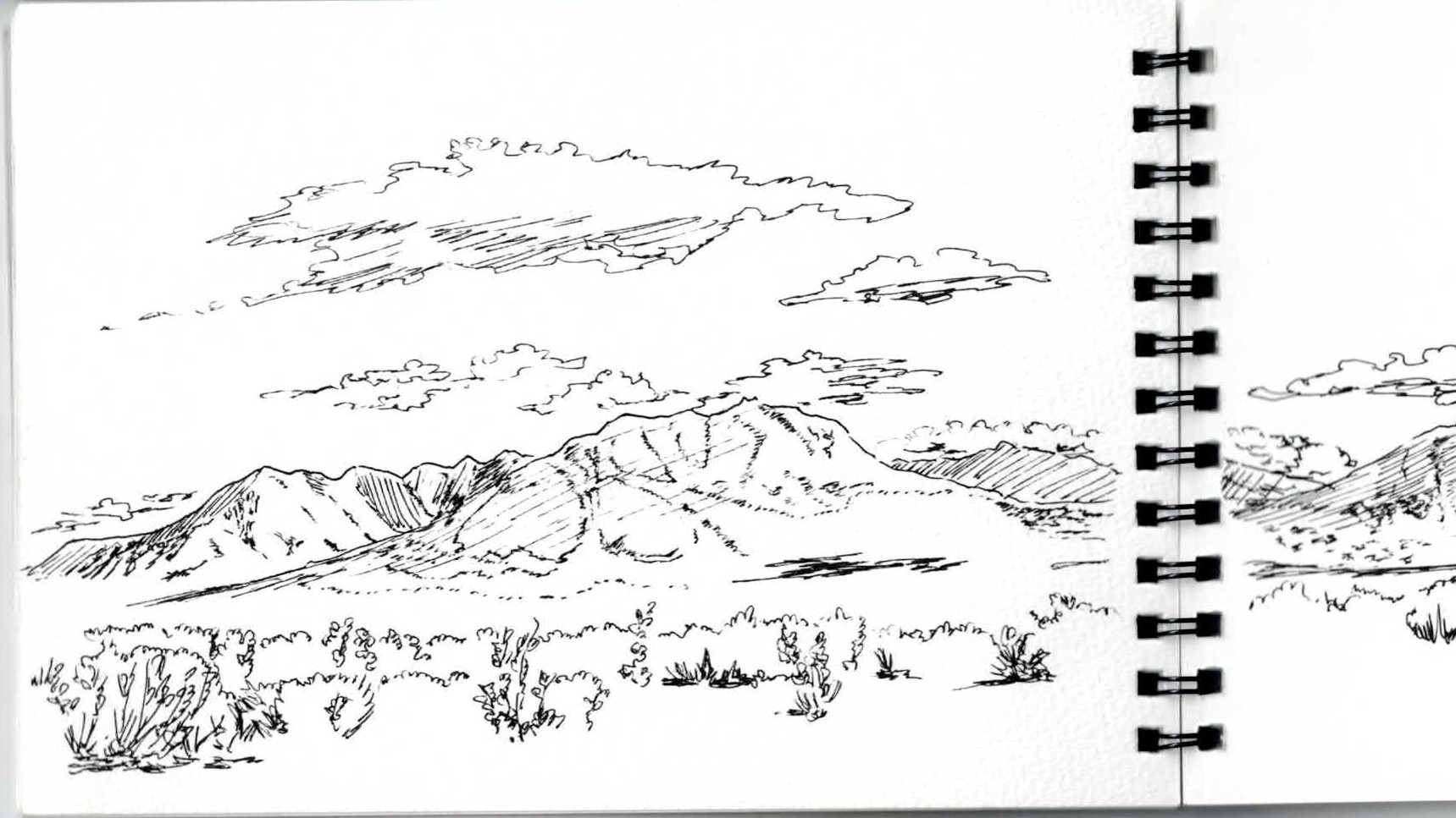 山の稜線を描いたスケッチブックの見開き
